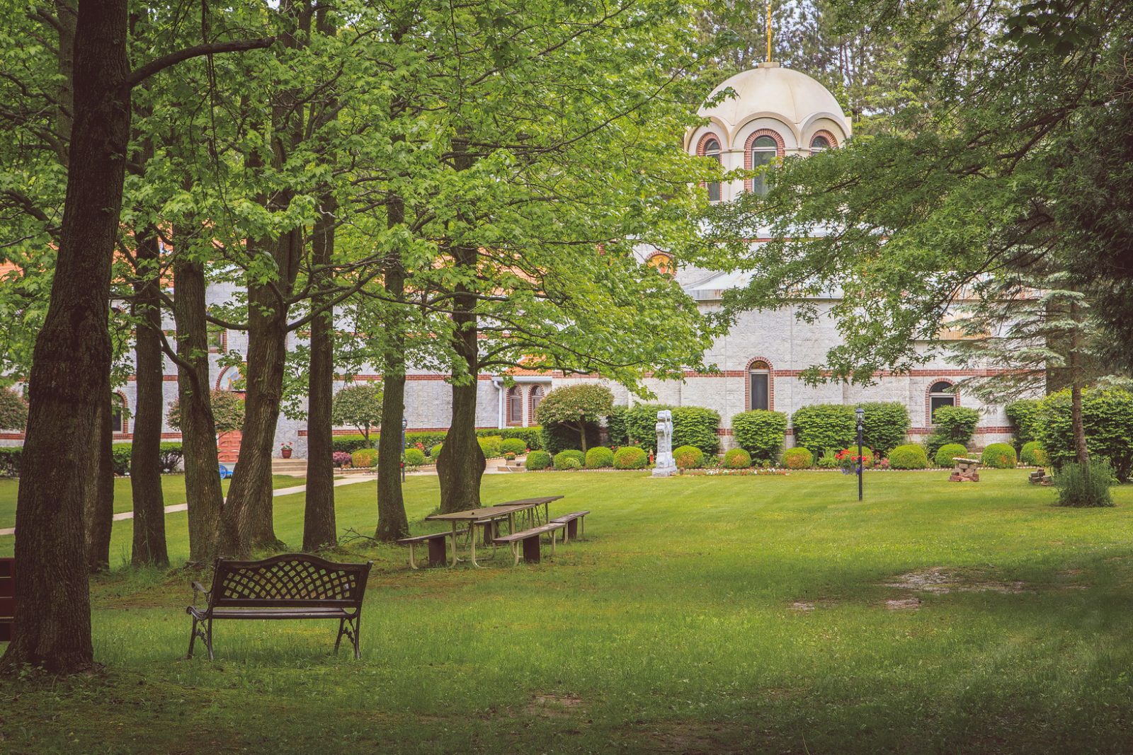 A bench on the wooded monastery grounds